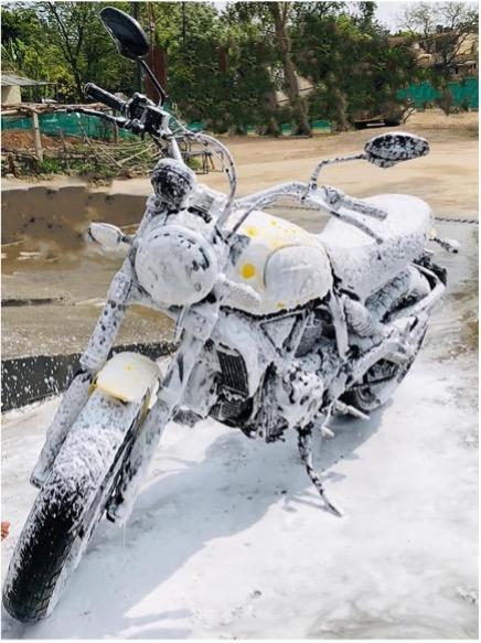 Moto avec mousse de nettoyage garée pour le lavage